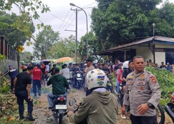 Personel Polsek Nusaniwe, Polresta Ambon mengatur lalu lintas pasca pohon tumbang di Taman Makmur.